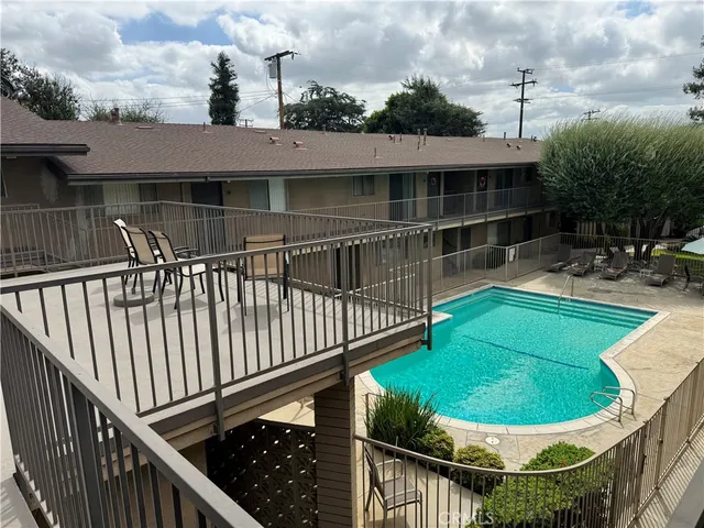 a view of a house with backyard and sitting area