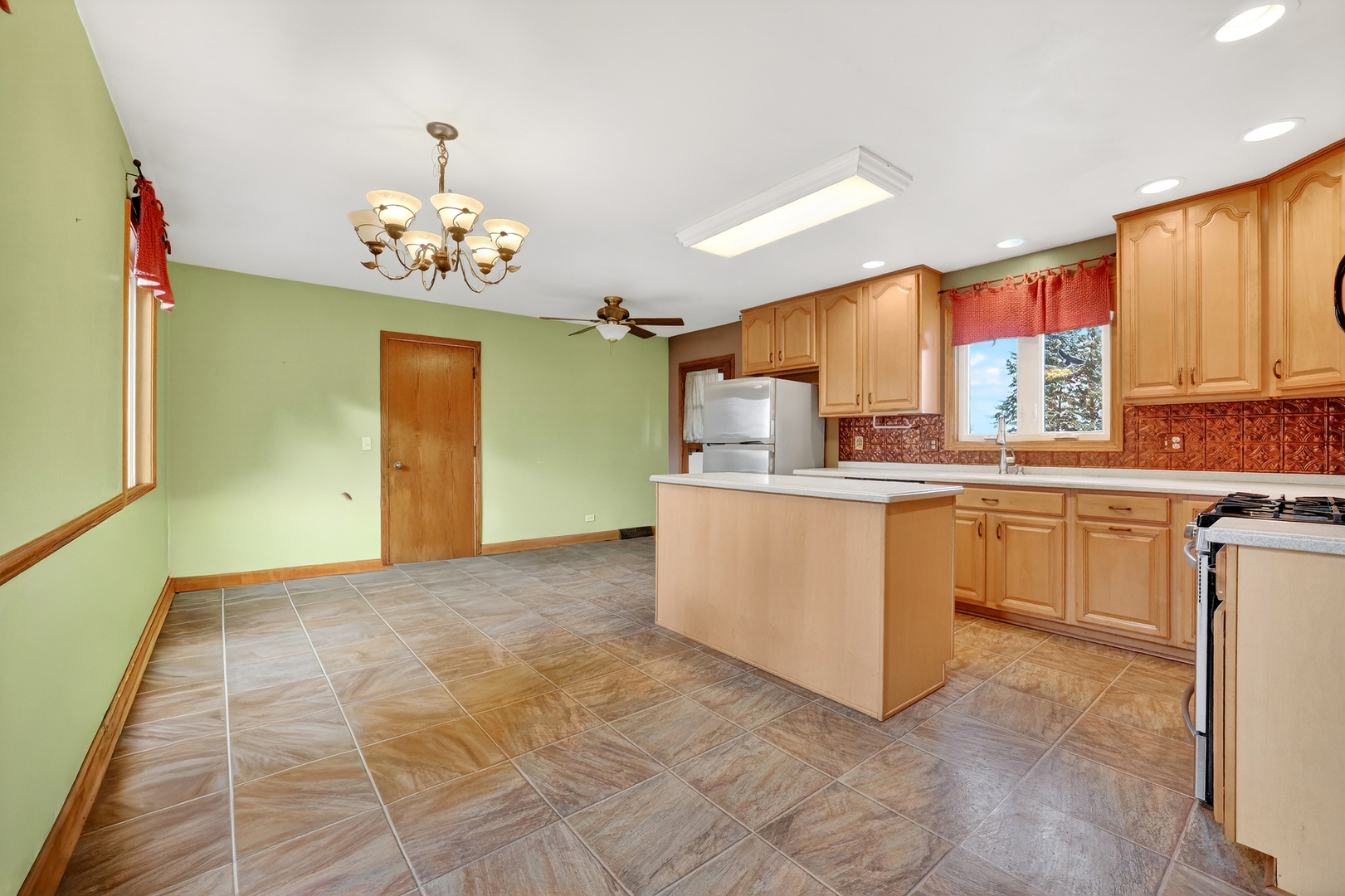 21230 Virginia Road DeKalb, IL 60115 - Photo 13 of 54 a kitchen with cabinets a sink stainless steel appliances and chandelier