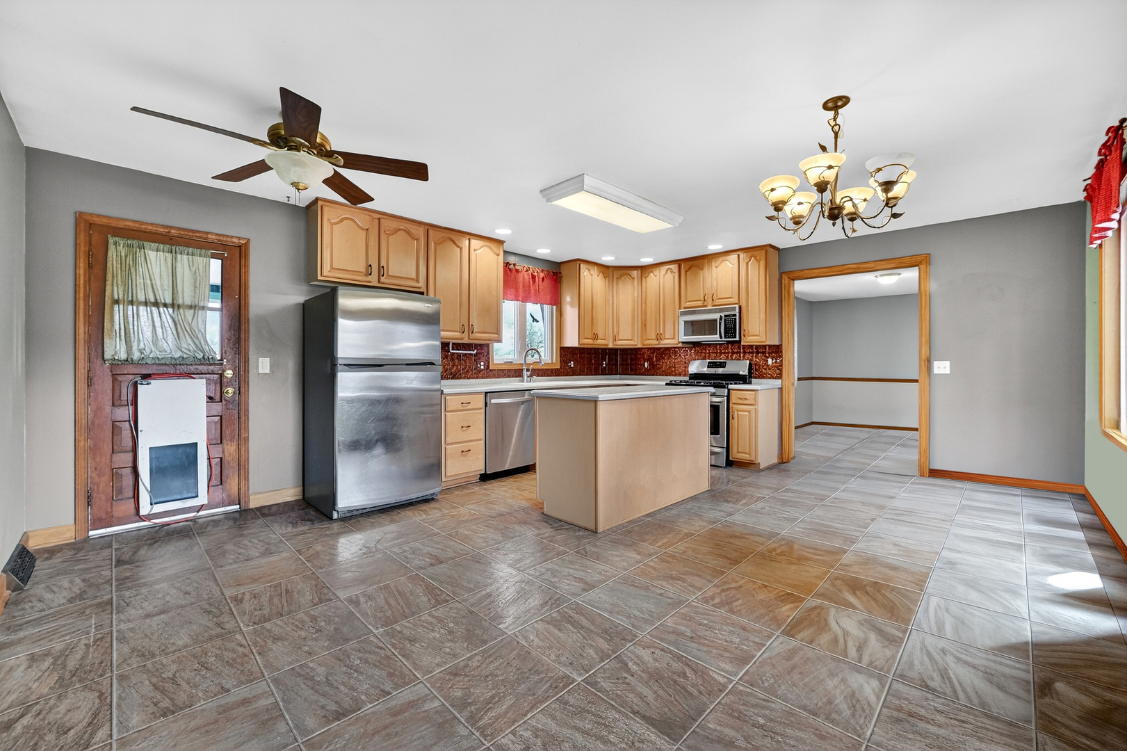 21230 Virginia Road DeKalb, IL 60115 - Photo 14 of 54 a kitchen with stainless steel appliances granite countertop a stove top oven a refrigerator and a sink