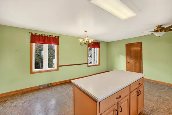 a kitchen with stainless steel appliances a sink cabinets and a window