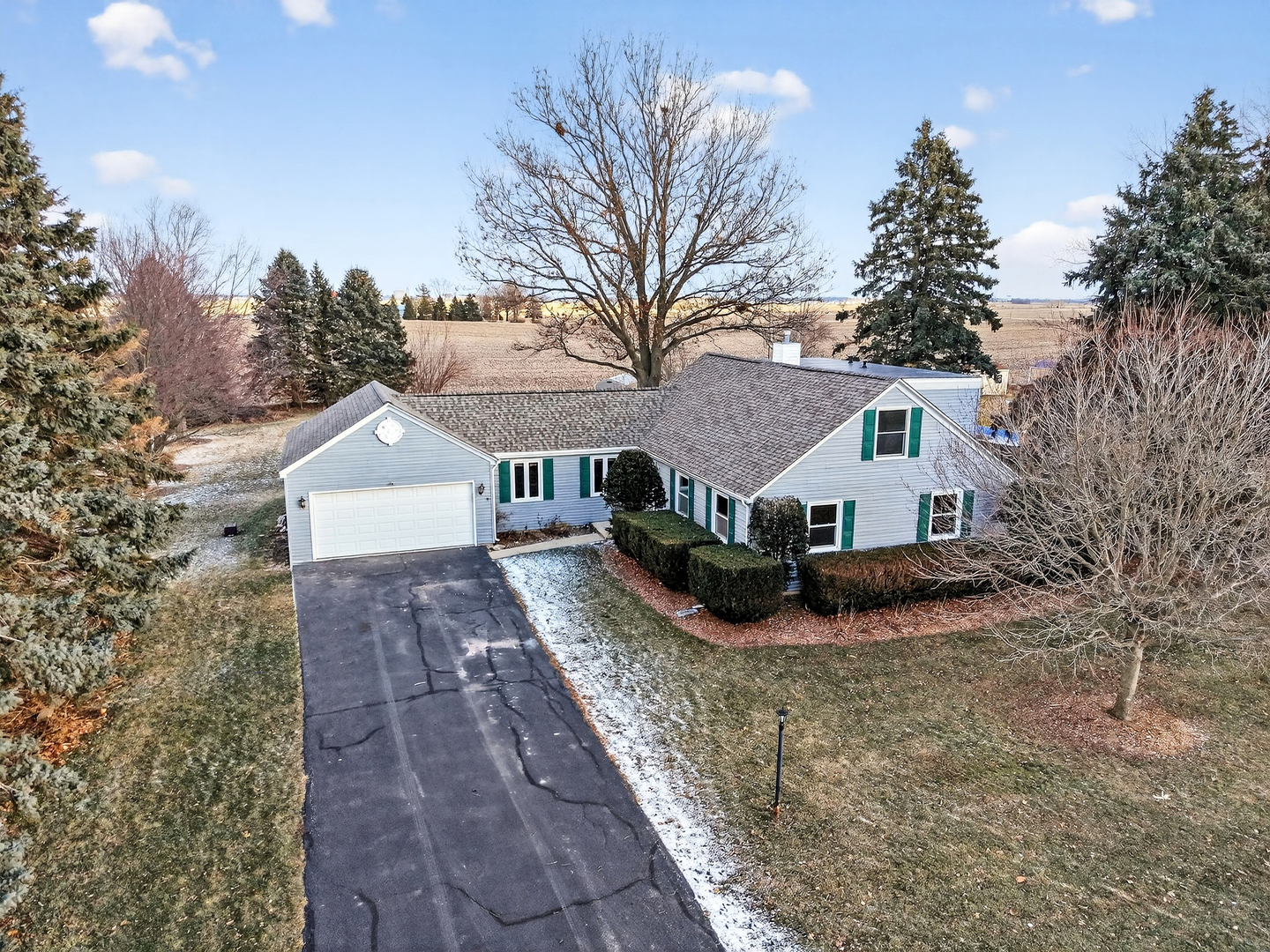 21230 Virginia Road DeKalb, IL 60115 - Photo 2 of 54 a view of house with yard and trees in the background
