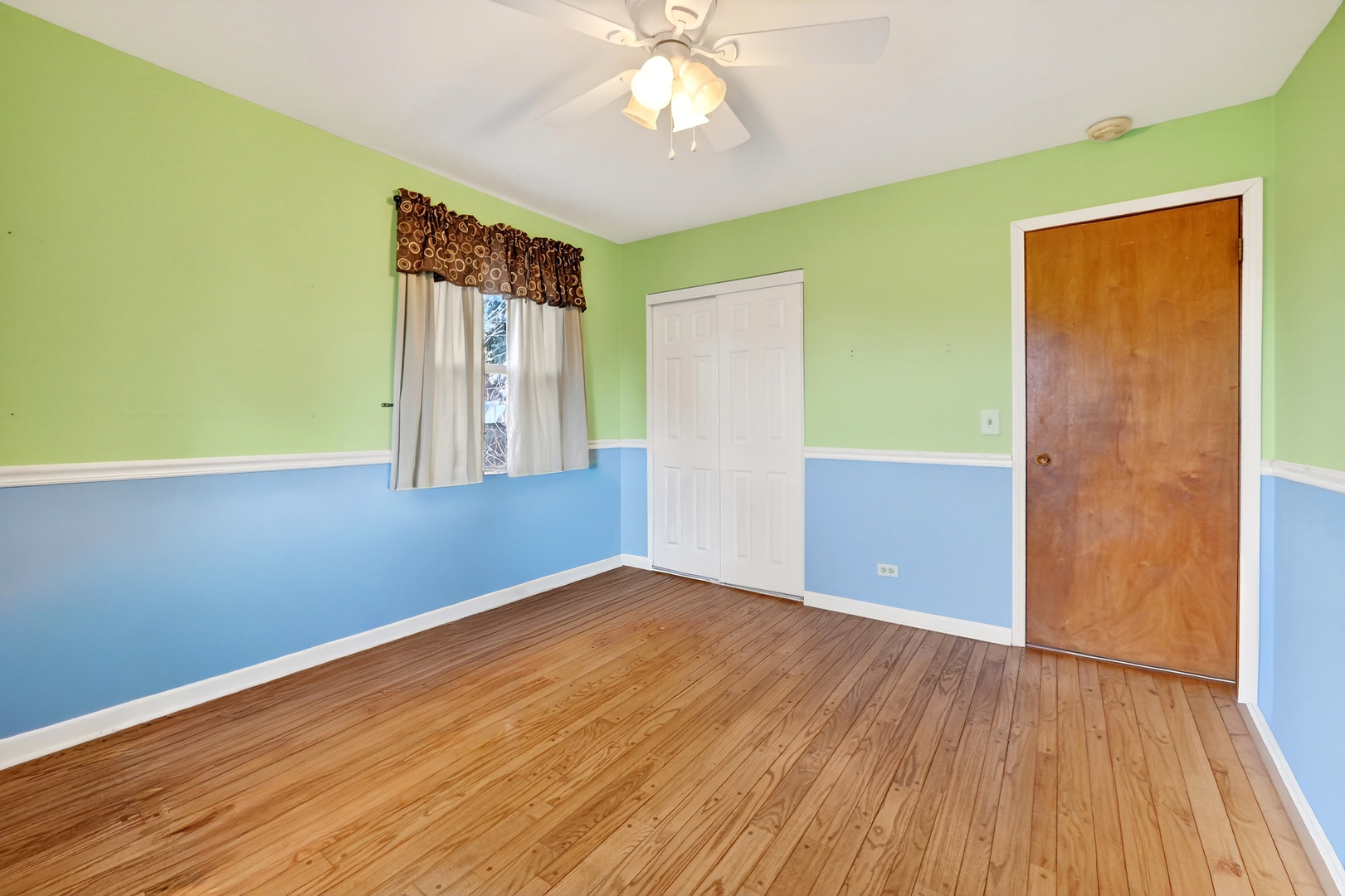 21230 Virginia Road DeKalb, IL 60115 - Photo 25 of 54 a view of an empty room with wooden floor and a window