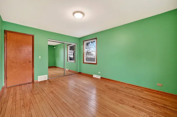 a spacious bedroom with a bed and a couch
