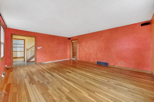 a living room with furniture a rug and a potted plant