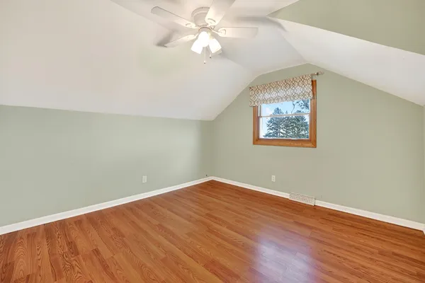 a bedroom with bed and a chandelier