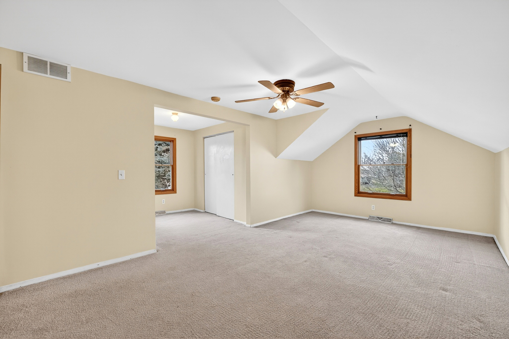 21230 Virginia Road DeKalb, IL 60115 - Photo 40 of 54 an empty room with a window and a ceiling fan