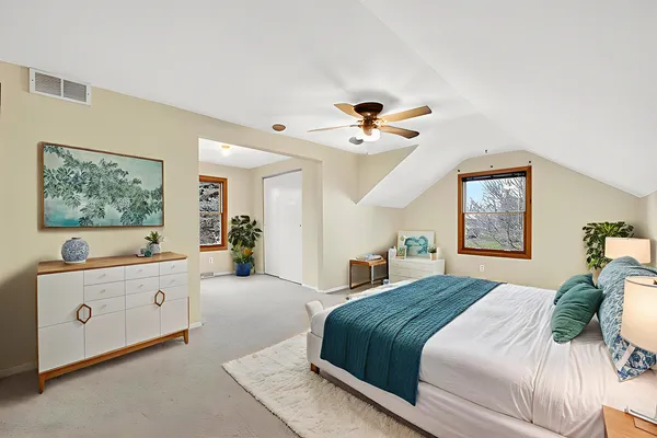 an empty room with a ceiling fan and a window