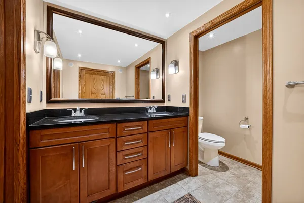 a bathroom with a toilet a sink and a mirror