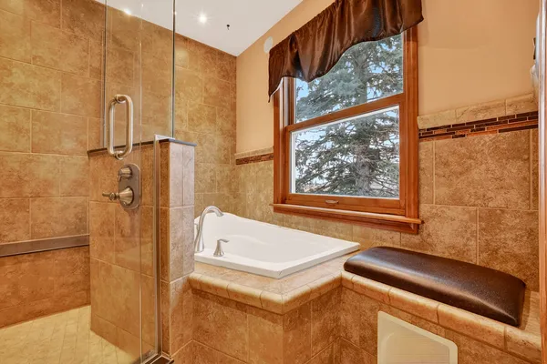 a bathroom with a bathtub and a shower