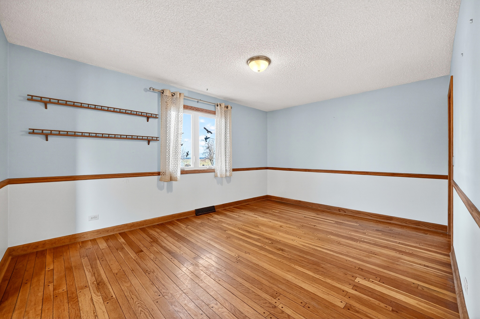 21230 Virginia Road DeKalb, IL 60115 - Photo 10 of 54 a view of an empty room with wooden floor