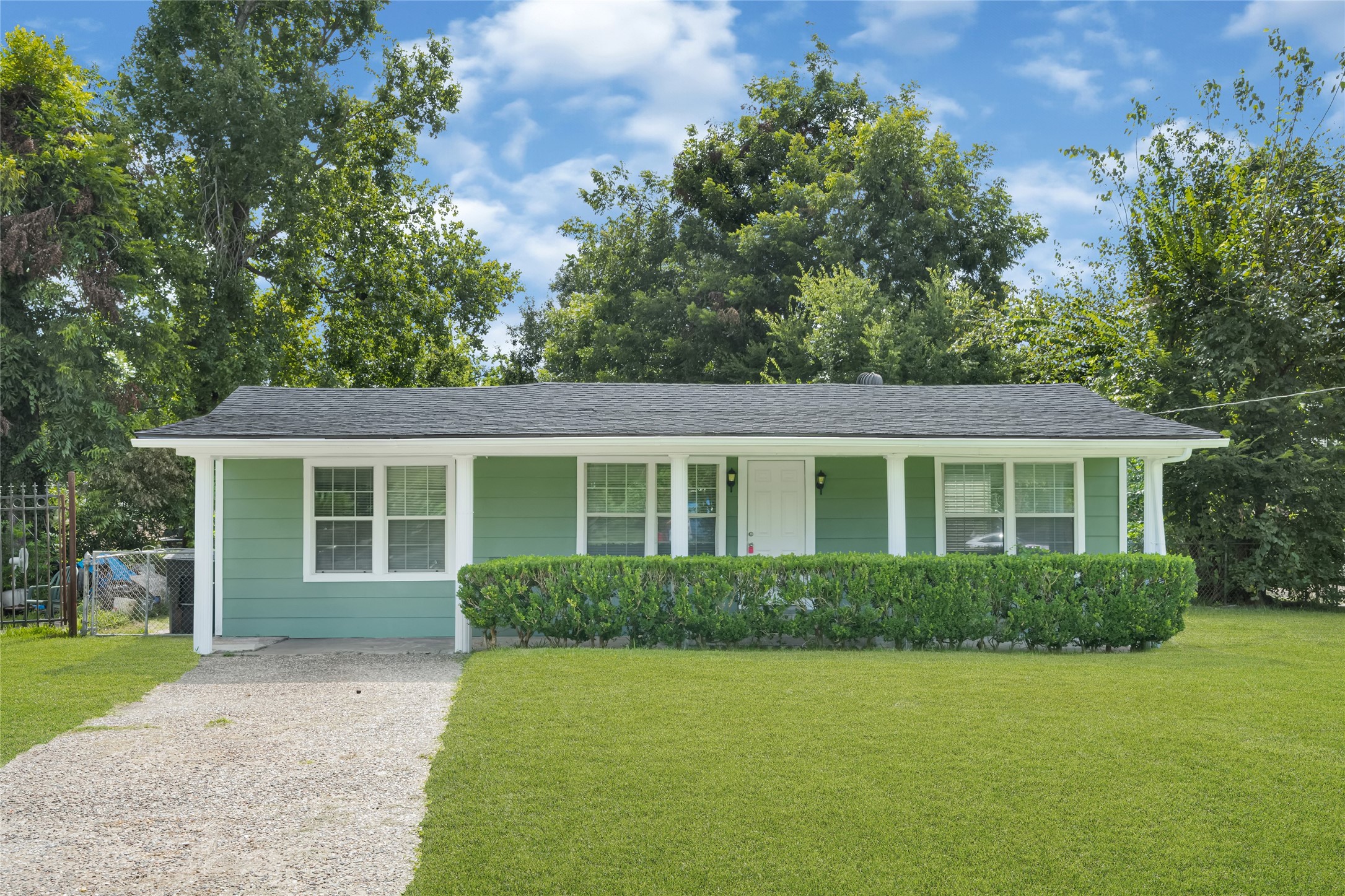9210 Compton Street Houston, TX 77016 - Photo 31 of 50 Delightful single-story home with a fresh green exterior, complemented by a neatly trimmed hedge and spacious front lawn, perfect for first-time buyers or downsizers.