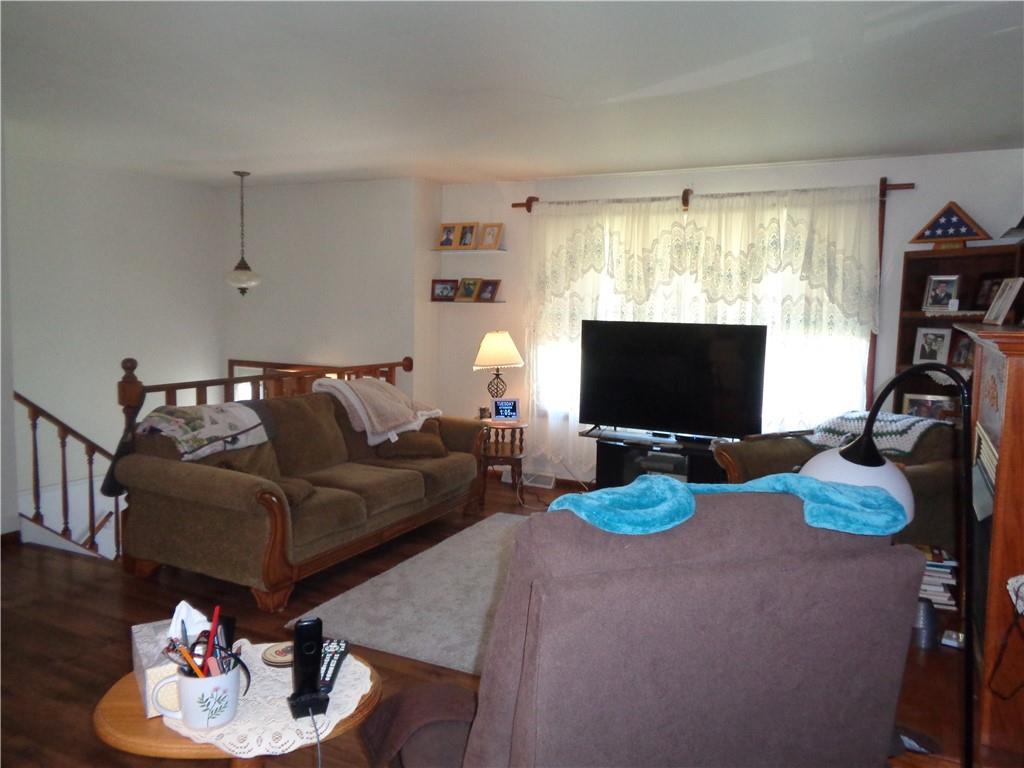 204 Gilchrist Road Uniontown, PA 15401 - Photo 17 of 22 a living room with furniture a flat screen tv and a large window
