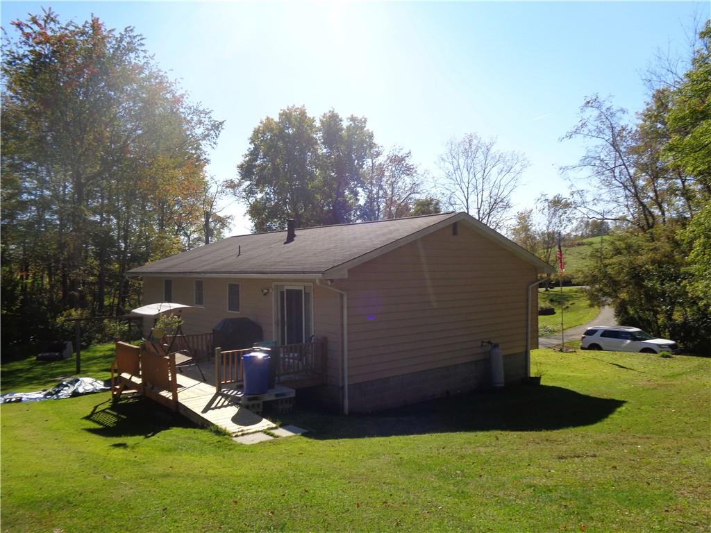 204 Gilchrist Road Uniontown, PA 15401 - Photo 5 of 22 a view of a backyard with table and chairs and a fire pit