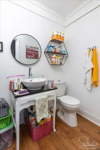 a bathroom with a toilet a sink and a mirror