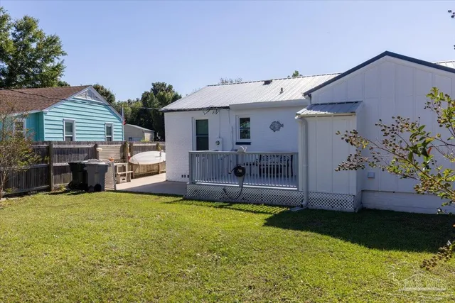 a view of a house with a yard and sitting area