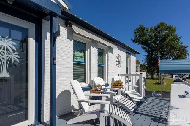 a view of a patio with couches table and chairs and potted plants