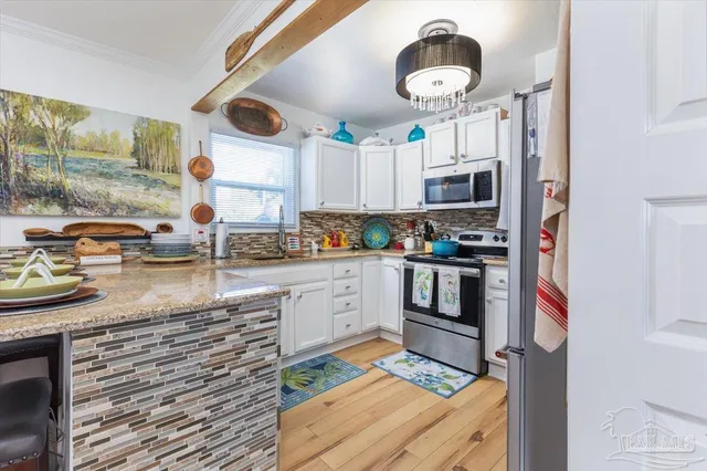 a kitchen with stainless steel appliances granite countertop a stove and a sink