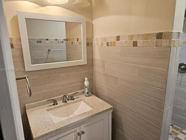 a bathroom with a sink and a mirror