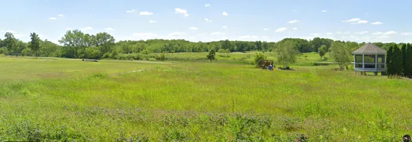 a view of a garden with a house