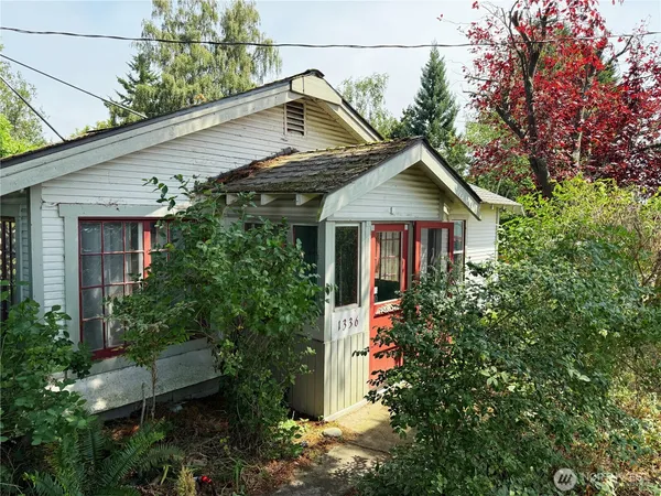 a view of a backyard with a garden and entertaining space