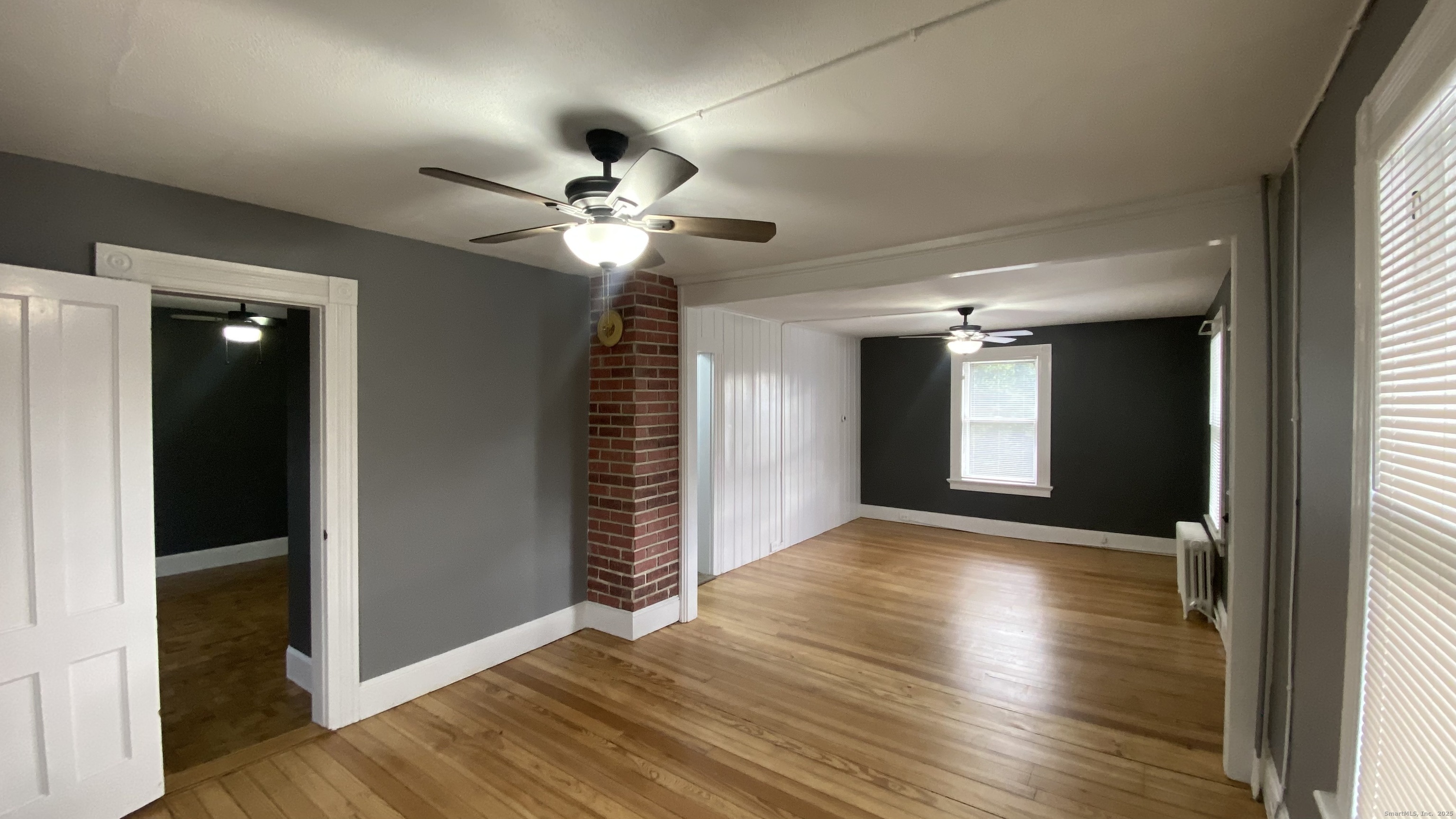 26 Pine Street, Unit 2 Torrington, CT 06790 - Photo 11 of 36 a view of an empty room with wooden floor and a window