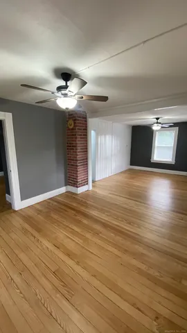 a view of an empty room and wooden floor
