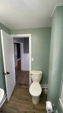 a white toilet sitting next to a bathroom sink
