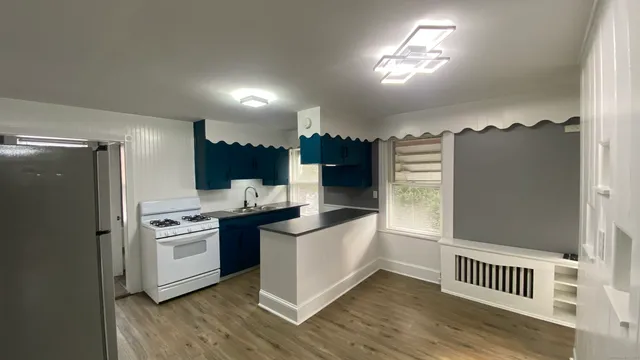 a kitchen with stainless steel appliances granite countertop a stove a refrigerator and a sink