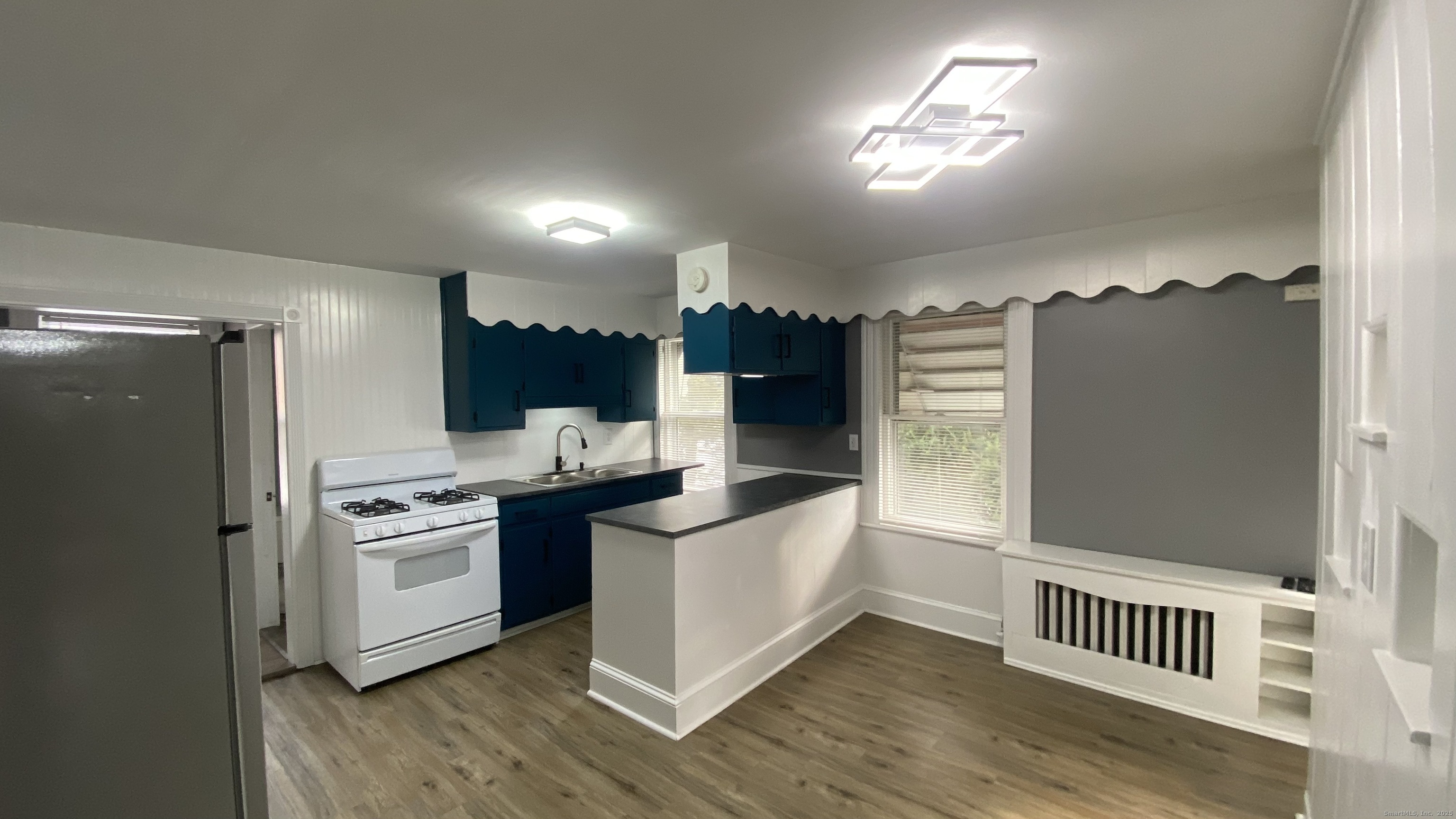 26 Pine Street, Unit 2 Torrington, CT 06790 - Photo 3 of 36 a kitchen with stainless steel appliances granite countertop a stove a refrigerator and a sink