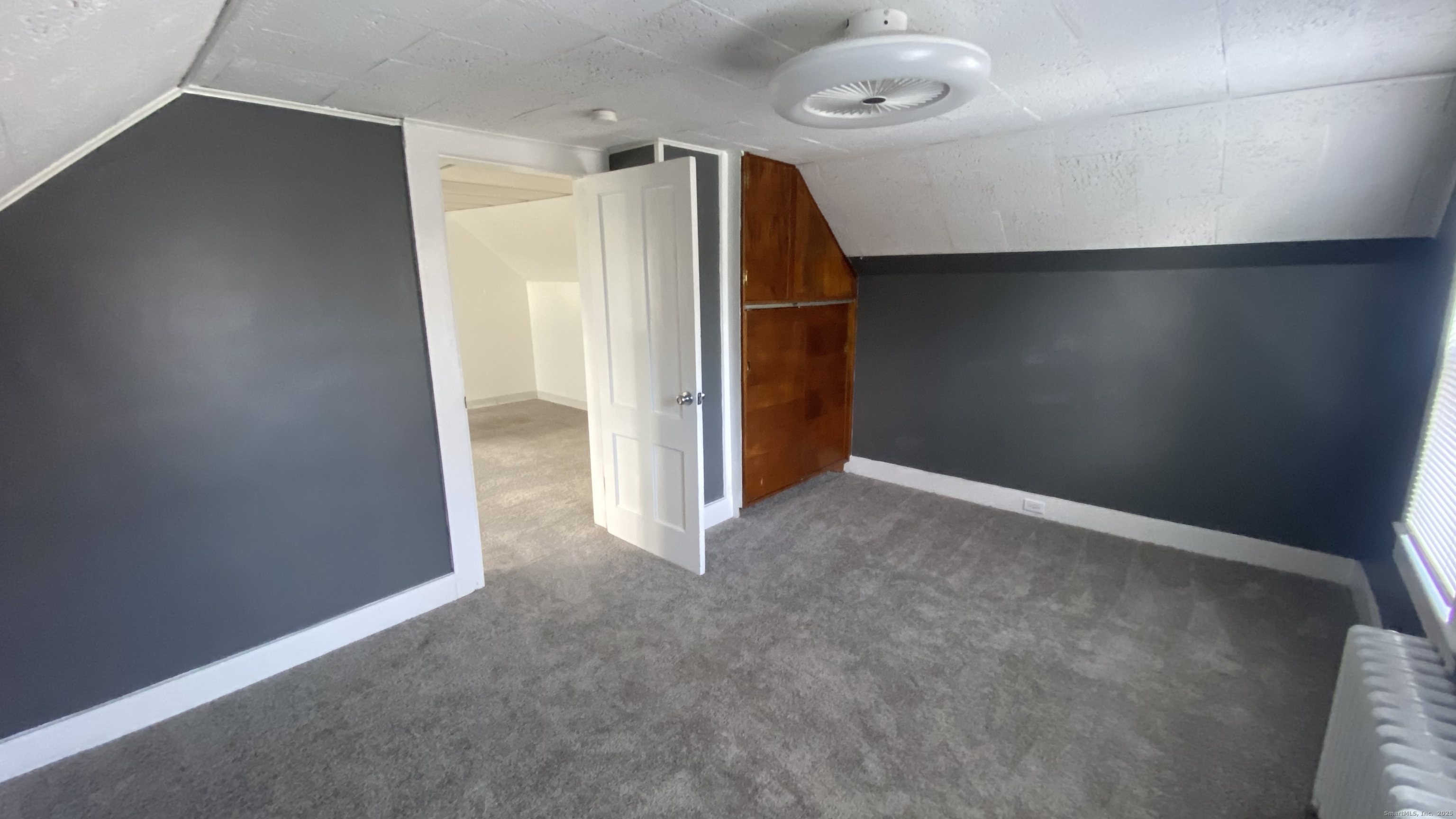 26 Pine Street, Unit 2 Torrington, CT 06790 - Photo 32 of 36 an empty room with a wooden shelves