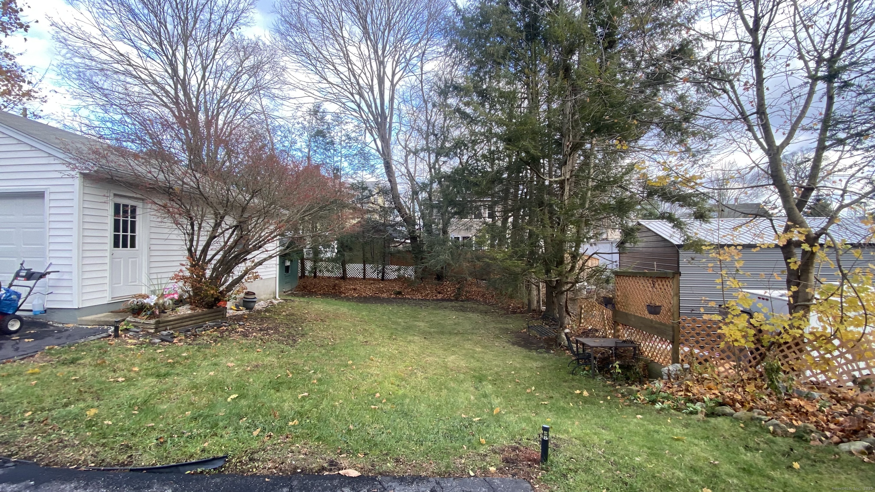 26 Pine Street, Unit 2 Torrington, CT 06790 - Photo 35 of 36 a view of a yard with a house and a large tree