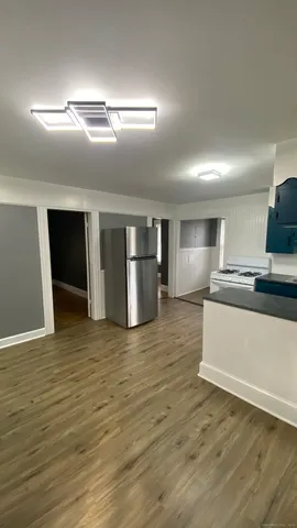 a view of kitchen with kitchen island microwave and sink