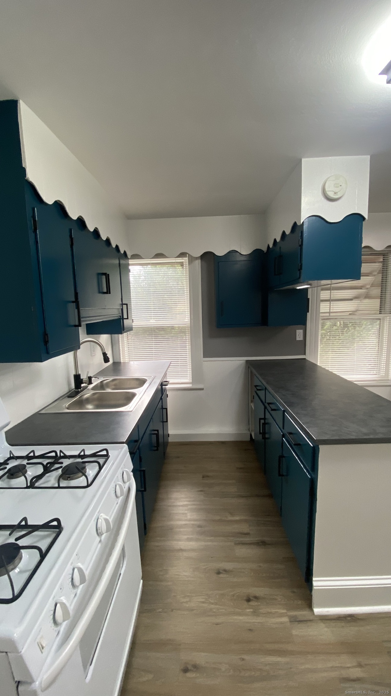 26 Pine Street, Unit 2 Torrington, CT 06790 - Photo 7 of 36 a kitchen with a stove and a sink