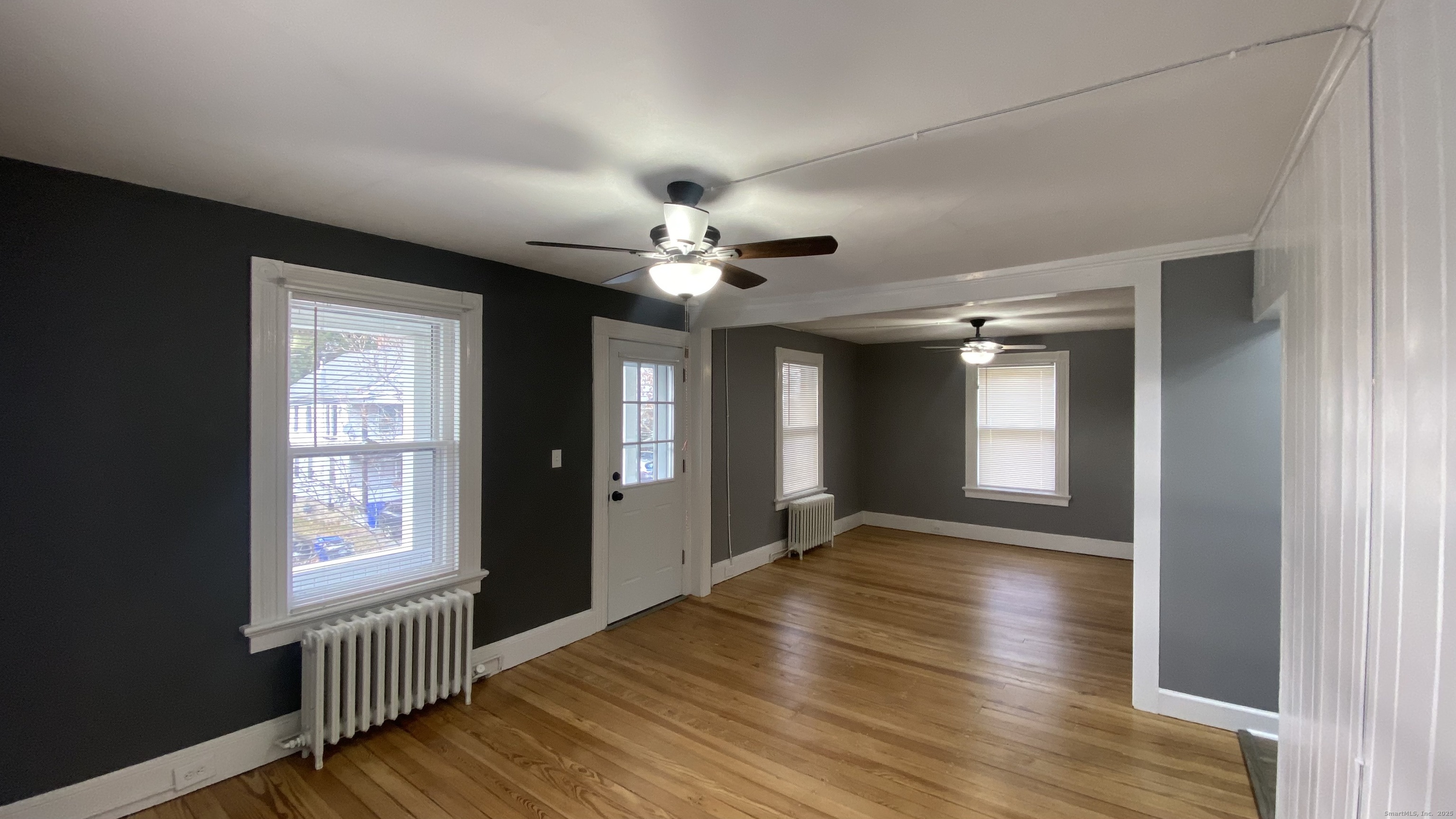 26 Pine Street, Unit 2 Torrington, CT 06790 - Photo 9 of 36 a view of an empty room with window and wooden floor
