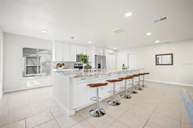 a kitchen with stainless steel appliances kitchen island granite countertop a sink and cabinets