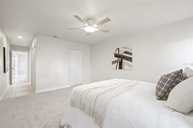 a bedroom with a large bed and a chandelier