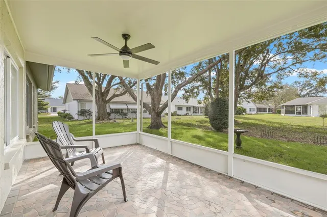a view of a porch with furniture and a yard