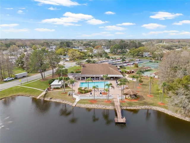 an aerial view of residential houses with outdoor space and swimming pool