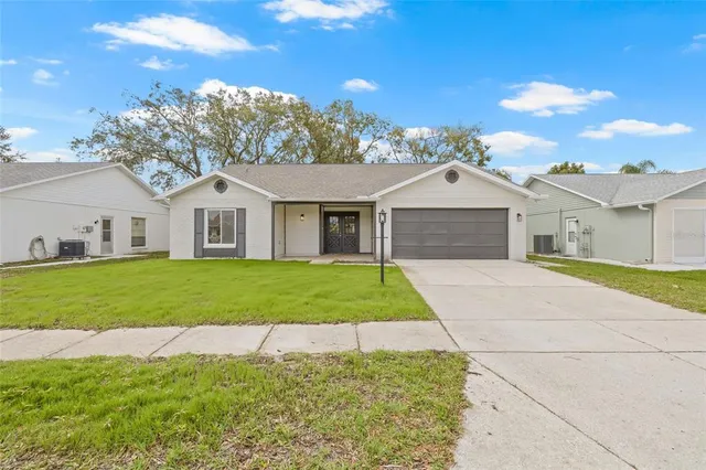 a view of a house with yard and tree s