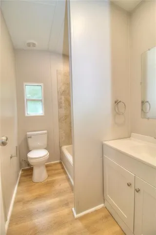 a bathroom with a toilet a sink and mirror
