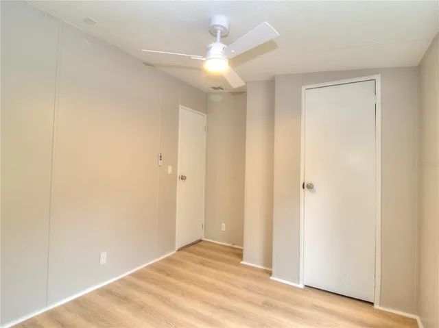 a view of a hallway with a chandelier fan