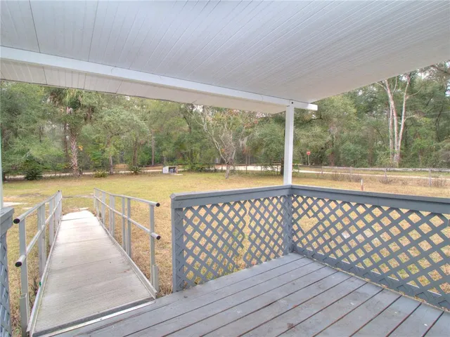 a view of a balcony with wooden floor