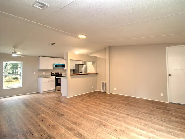 a view of kitchen with wooden floor