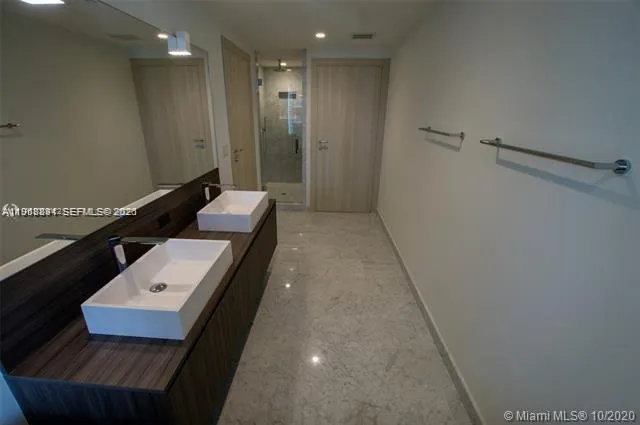 a bathroom with a sink a toilet and mirror