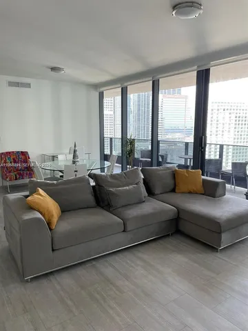 a living room with furniture and a large window