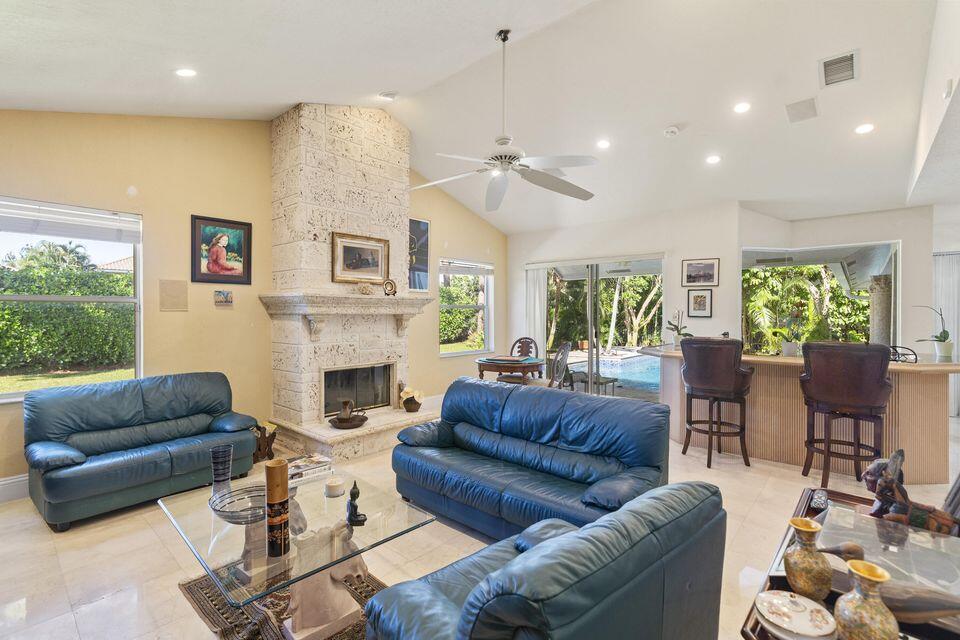 3271 Harrington Drive Boca Raton, FL 33496 - Photo 11 of 43 a living room with furniture a fireplace and a large window