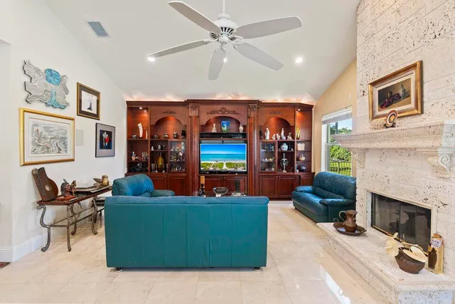 a dining room with furniture a chandelier and wooden floor