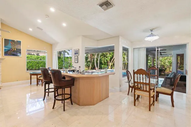 a bedroom with a large bed couch and a large window