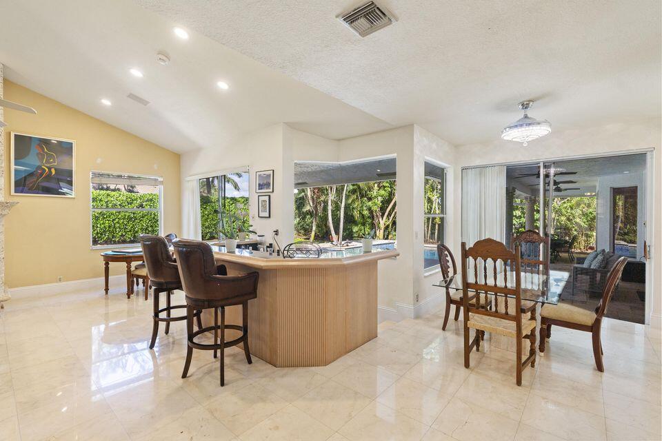 3271 Harrington Drive Boca Raton, FL 33496 - Photo 13 of 43 a dining room with furniture a chandelier and wooden floor