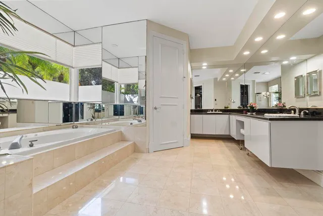 a bathroom with a tub and a shower